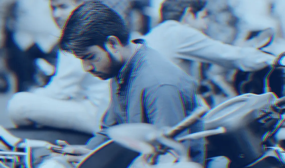 A man holding a smartphone in India