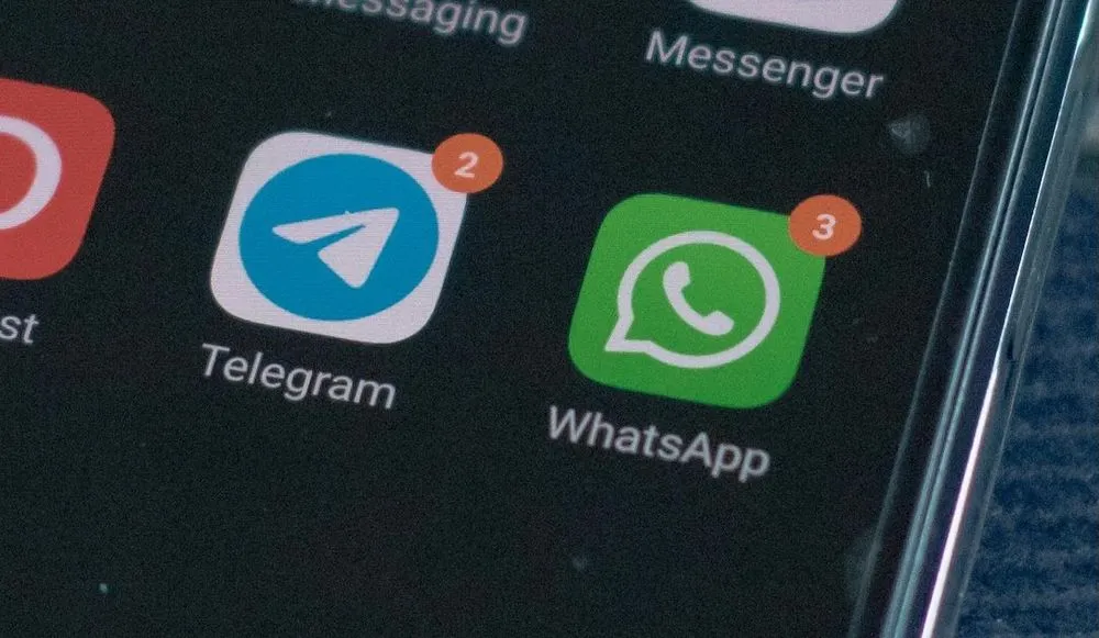 Telegram icon and WhatsApp icon on a smartphone