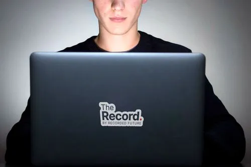 A man typing on a laptop