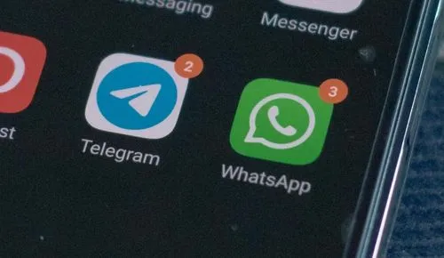 Telegram icon and WhatsApp icon on a smartphone